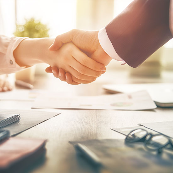 Closeup of hands shaking in a deal